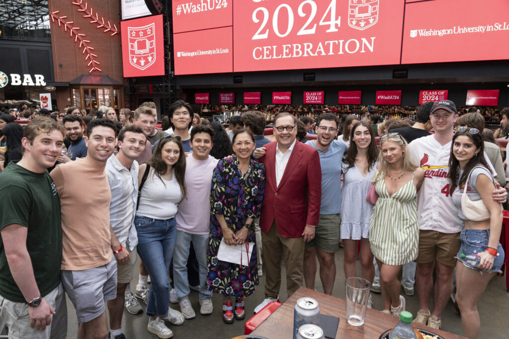 Graduates pose for a photo with Chancellor Martin during the 2024 graduation party