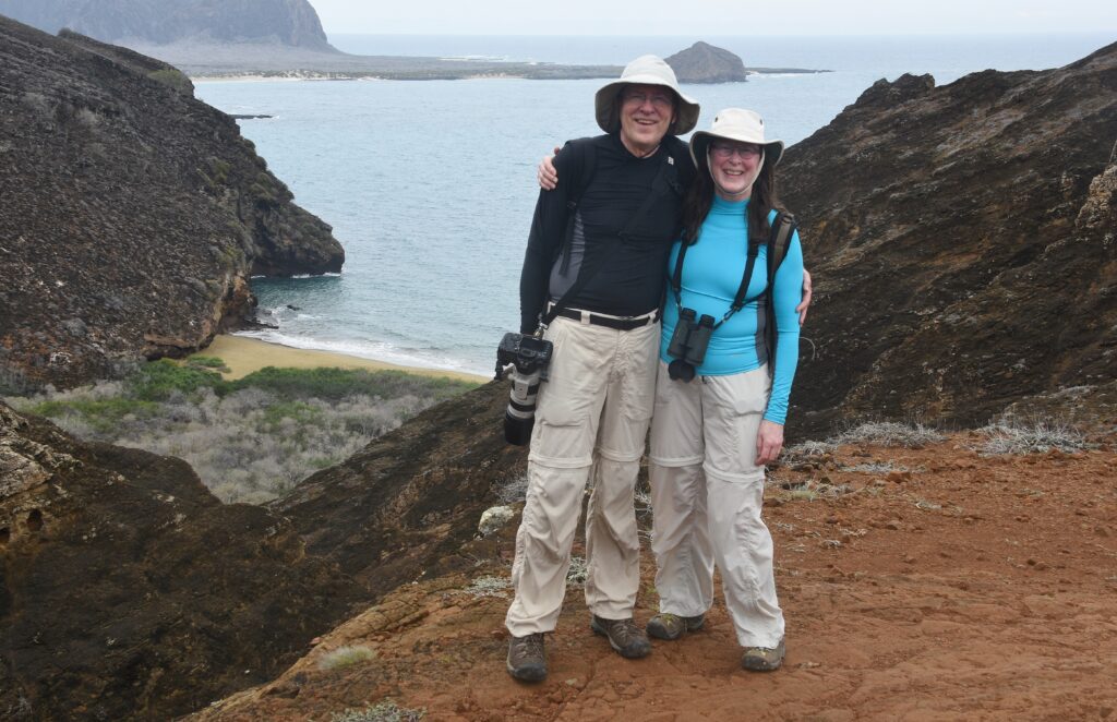 Couple with cameras in front of bay 