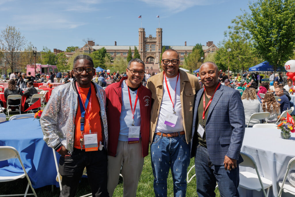 A group of older alums pose for a photo