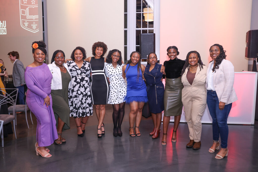 WashU alums pose for a photo during their class party