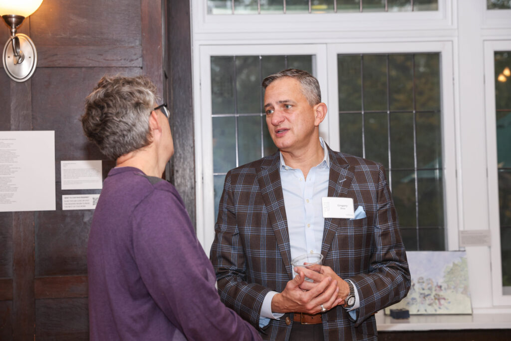 Two alums engage in a conversation during the WUpan turns 10 reception in October 2023