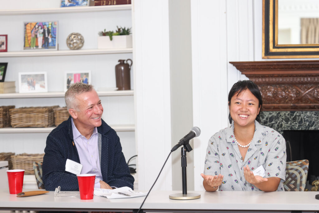 Two panel members smile during the WUpan turns 10 reception in October 2023