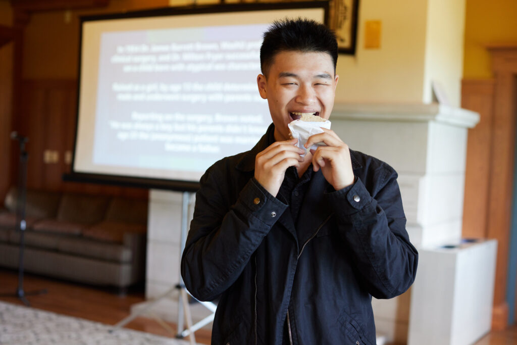 An alum eating a treat during the 2024 WashU Pride alumni network reception