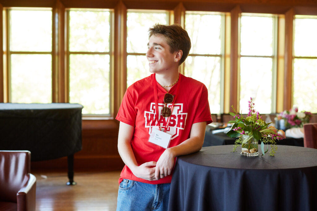 An alum wearing a WashU t-shirt at the 2024 WashU Pride alumni network reception