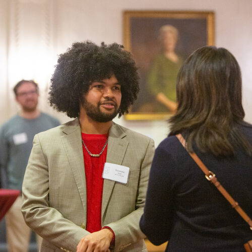 Two hispanic students chat during a meeting