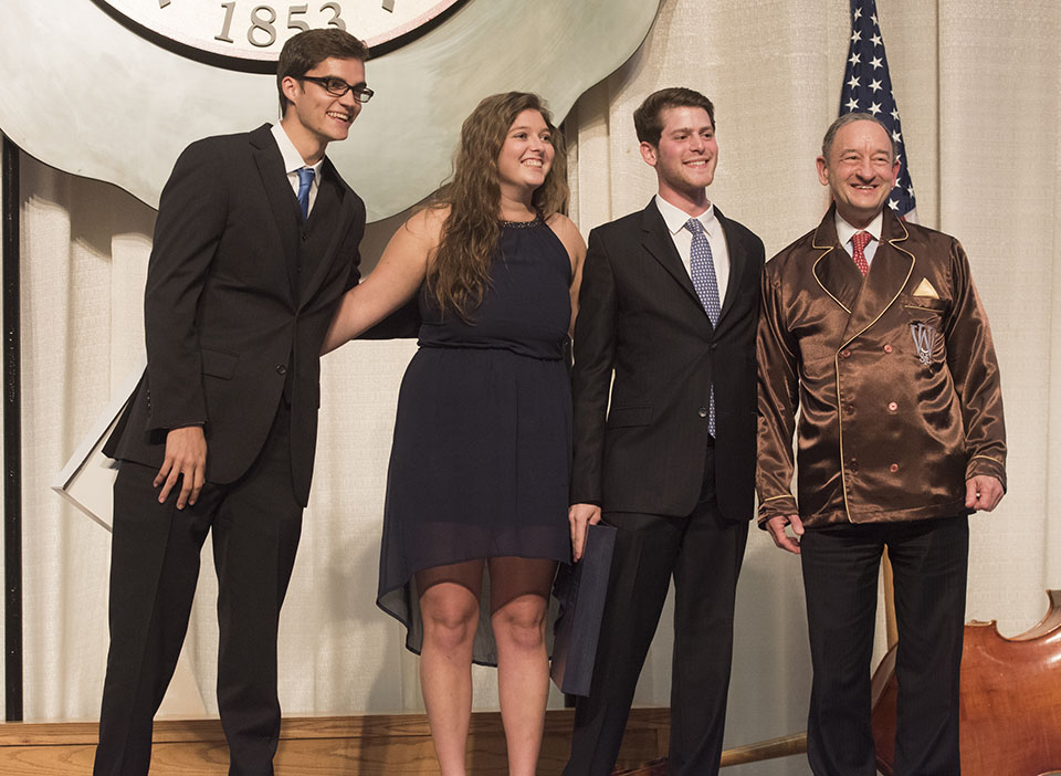 Sherman (third from left) presents Chancellor Mark S. Wrighton with this year’s senior gift, a pair of double-breasted pajamas, at the Chancellor’s Dinner at the America’s Center. Sherman is joined by fellow senior officers Jack Krewson (left) and Marli Komarek.