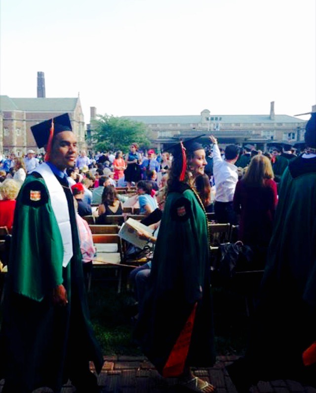 two students walking at commencement