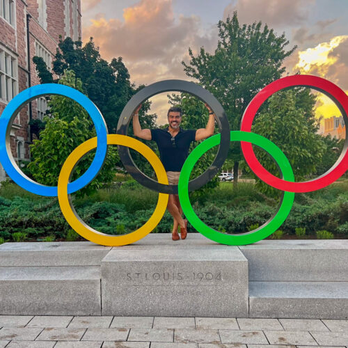 Mario Treto in front of the Olympic rings at WashU