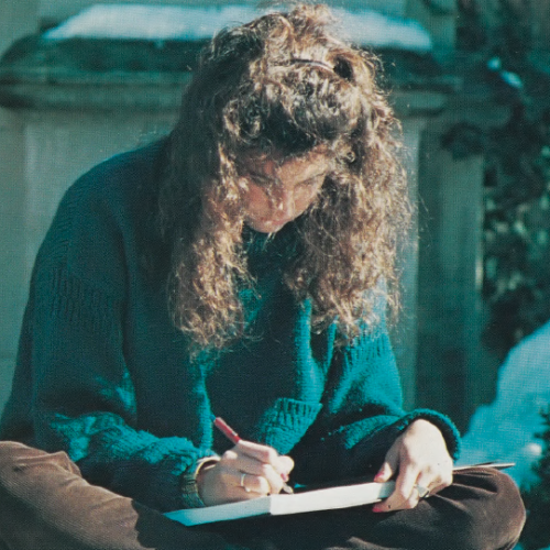 Color photo of WashU student in the 1980s studying on a snow-covered campus