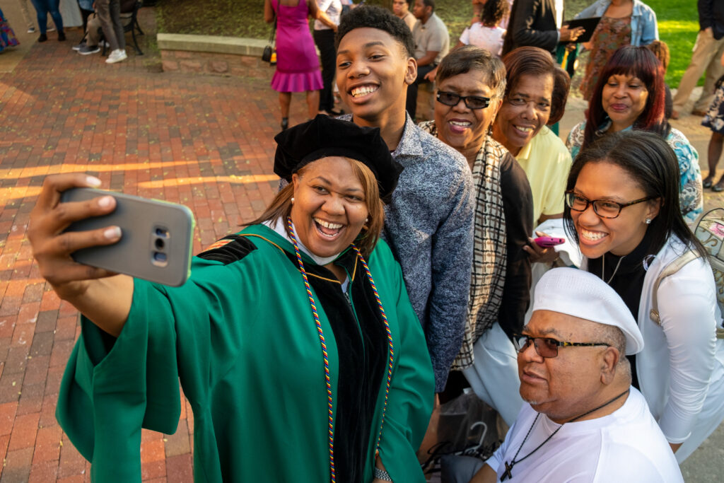 Graduate taking a selfie with friends and family