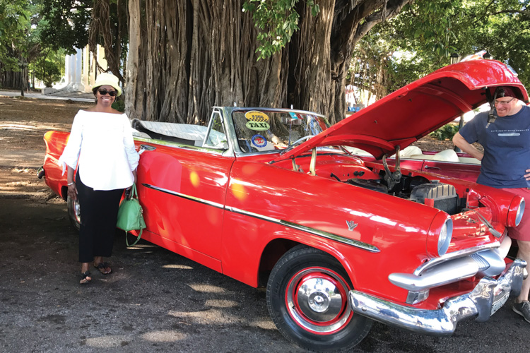 WashU alums enjoying a classic car show in Cuba