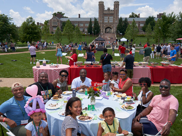 A family enjoying the Alumni BBQ on the East End of Danforth Campus