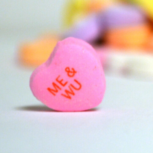 Candy heart that says "ME & WU"