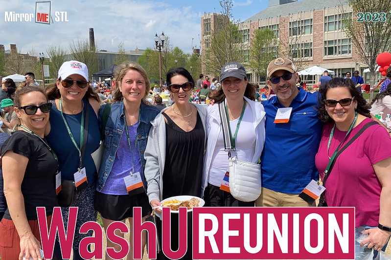 Alumni pose for a picture during Alumni Barbecue in Tisch Park; a special border around the picture spells out 'WashU Reunion' in red and white