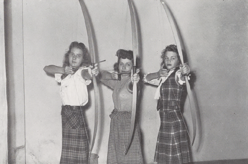 Black and white photo women archers holding their bows.