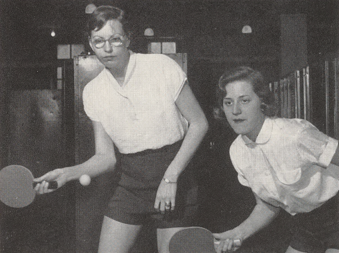 Black and white photo of two women playing table tennis