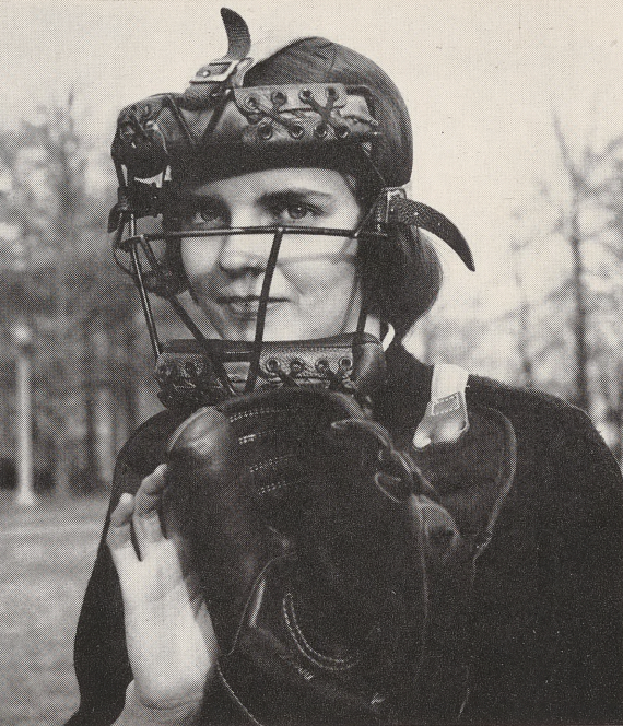 Black and white photo of a woman in a catcher's uniform