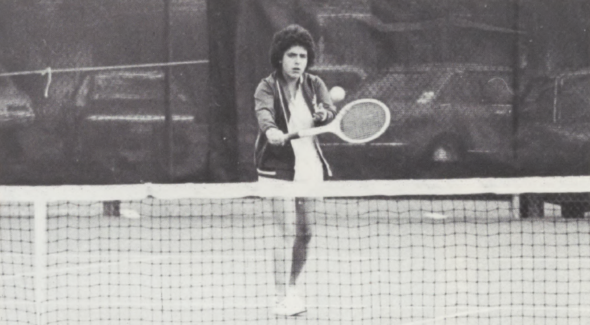 Black and white photo of a woman playing tennis in 1977