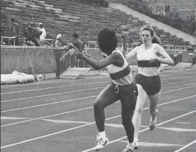 Black and white photo of women on a track