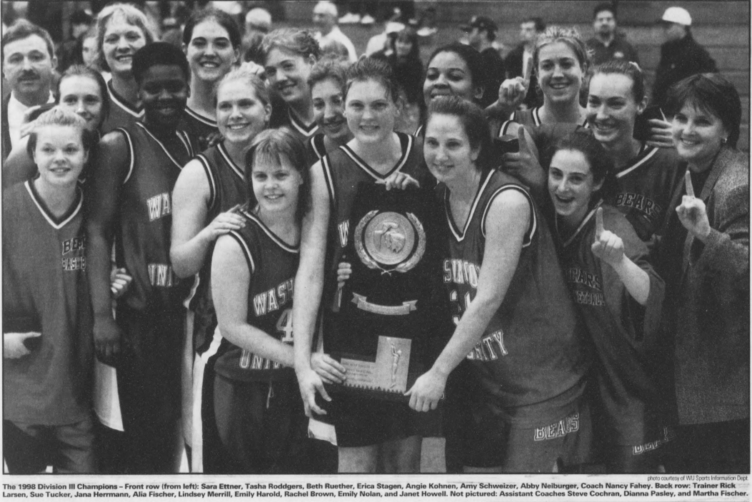 Black and white photo of a women's basketball team posing with a championship trophy